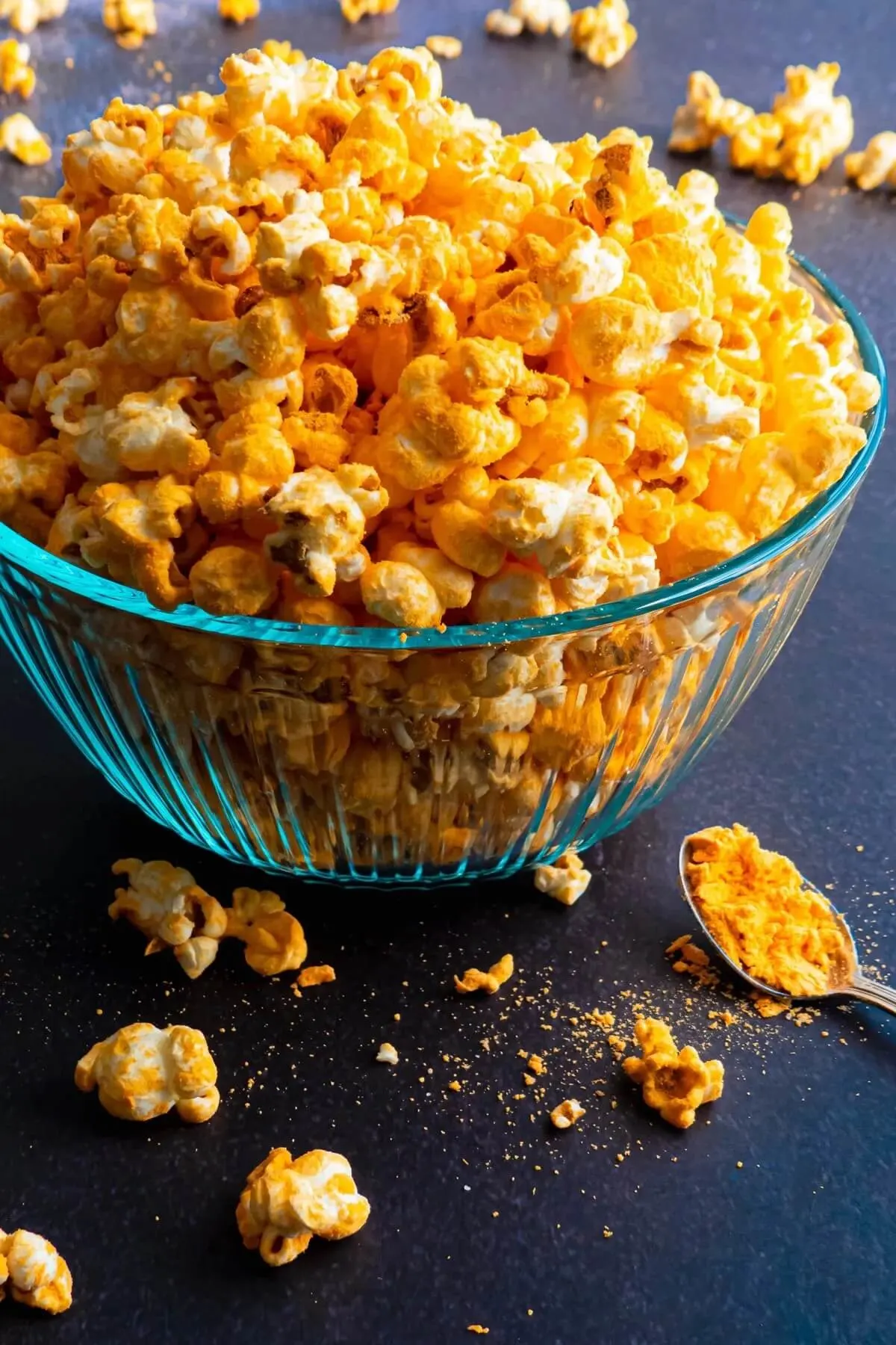 Cheese popcorn overflowing from glass bowl