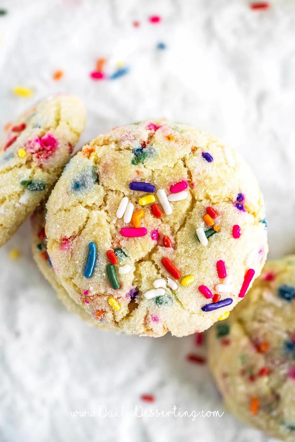 Stack of funfetti cookies with sprinkles scattered