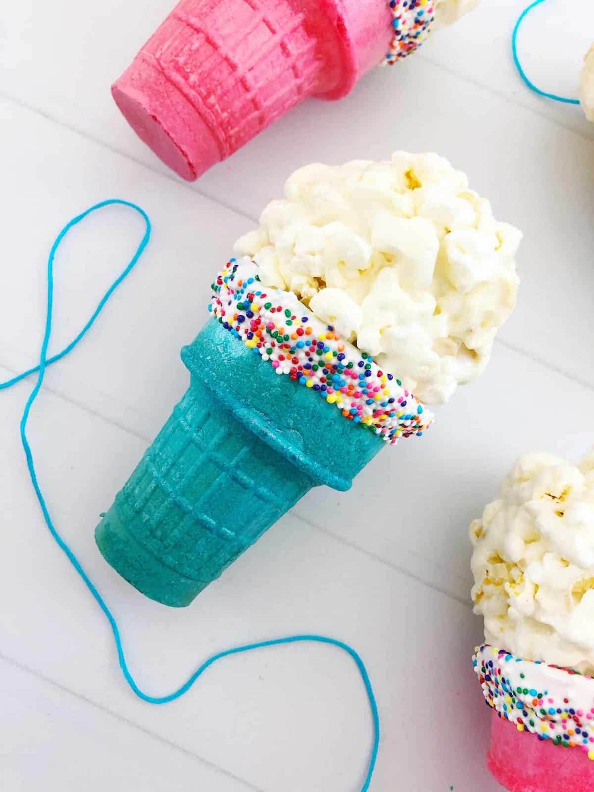 Popcorn ball ice cream cone in blue cone
