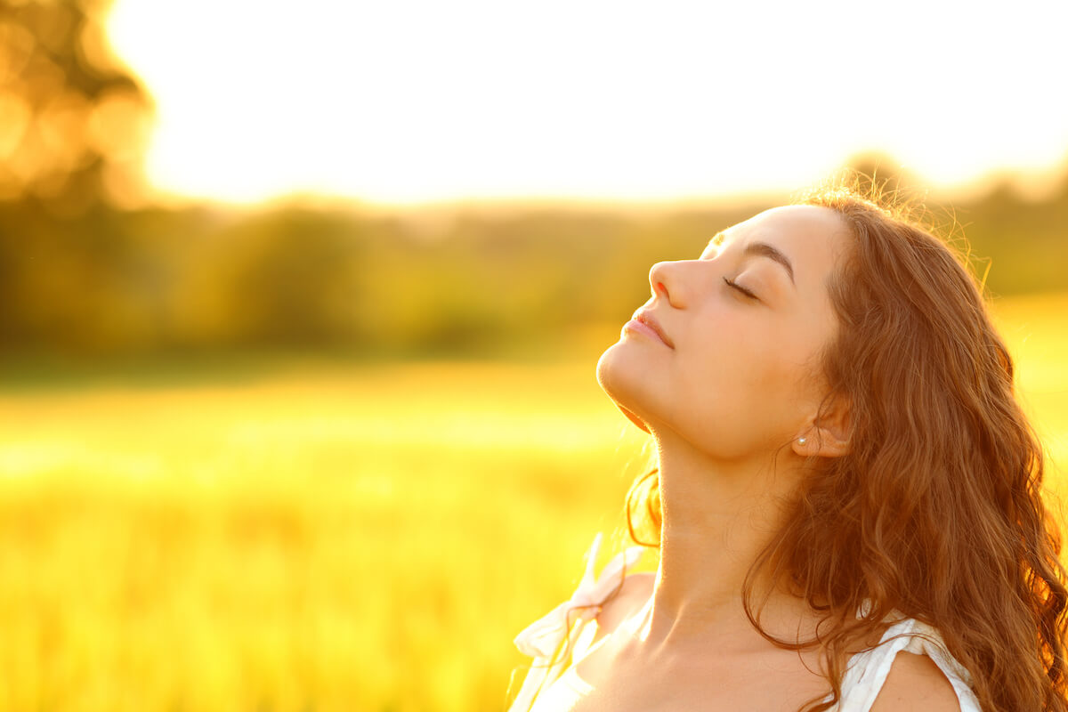 Woman outdoors with sunshine on her face