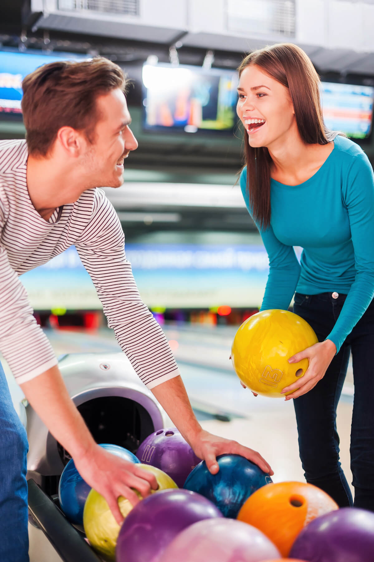 Couple having fun while at the bowling alley