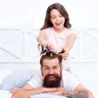 daughter styling fathers hair