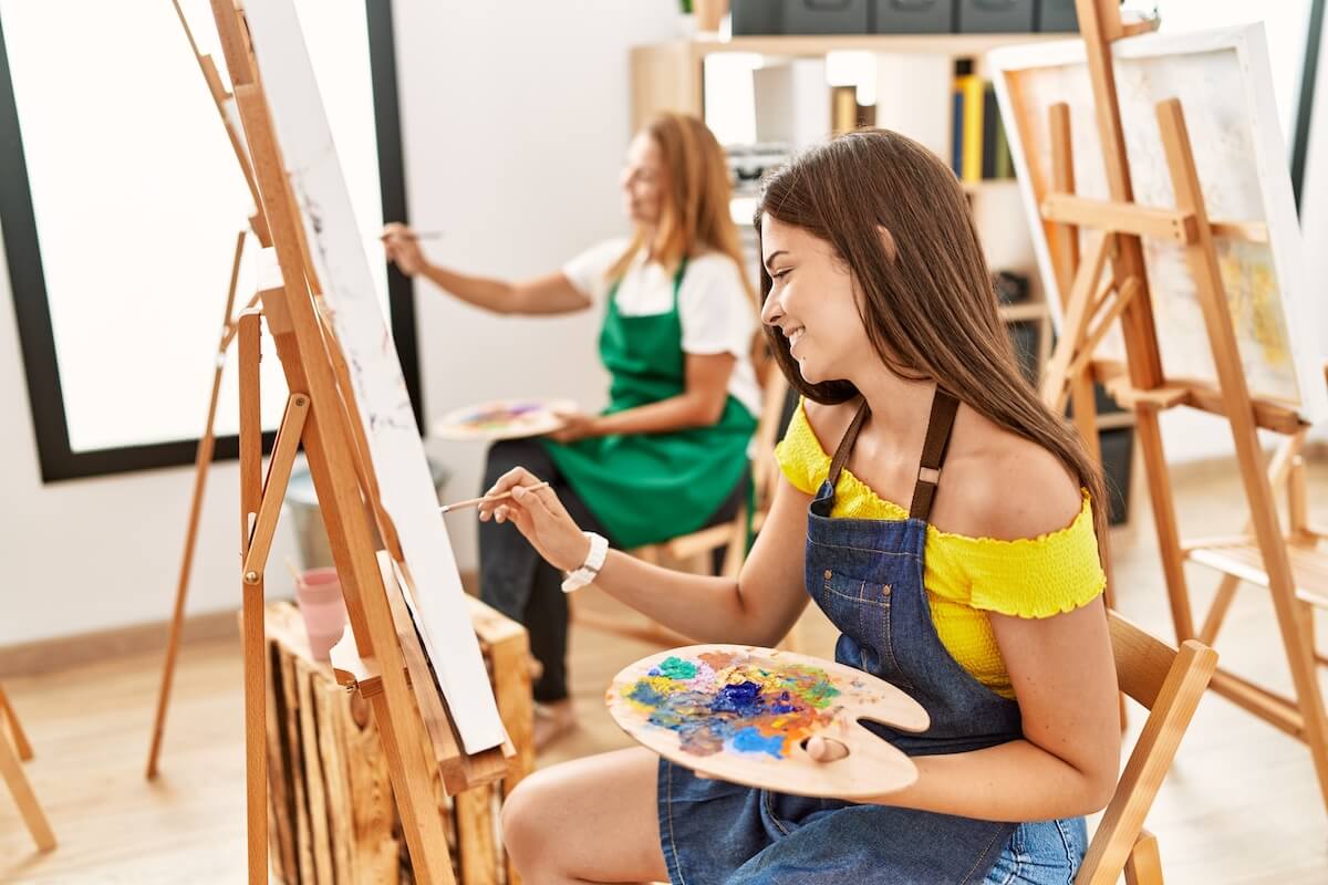 Mother and teen daughter doing a painting class