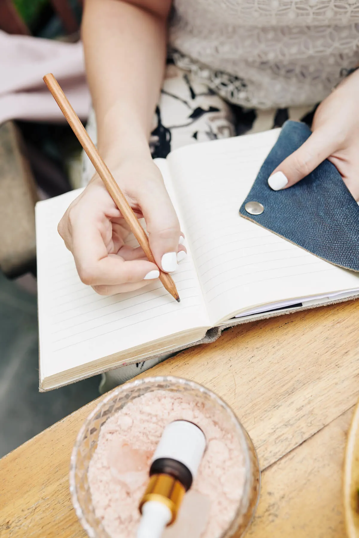 woman writing in journal with pencil