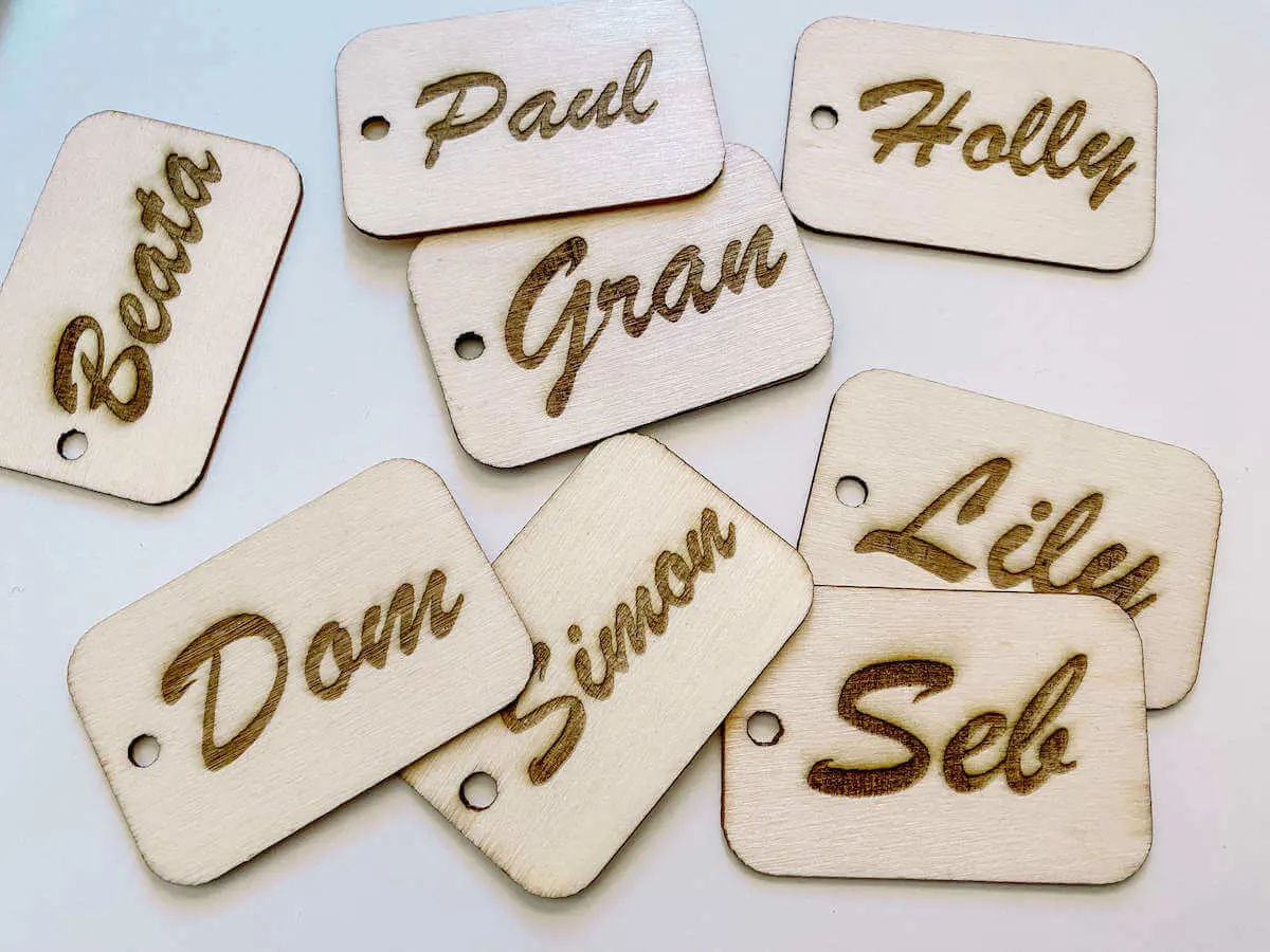 Wooden engraved gift tags with names on them