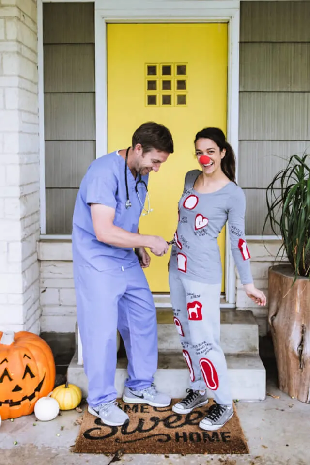 Man and woman dressed as doctor in scrubs and the board game operation