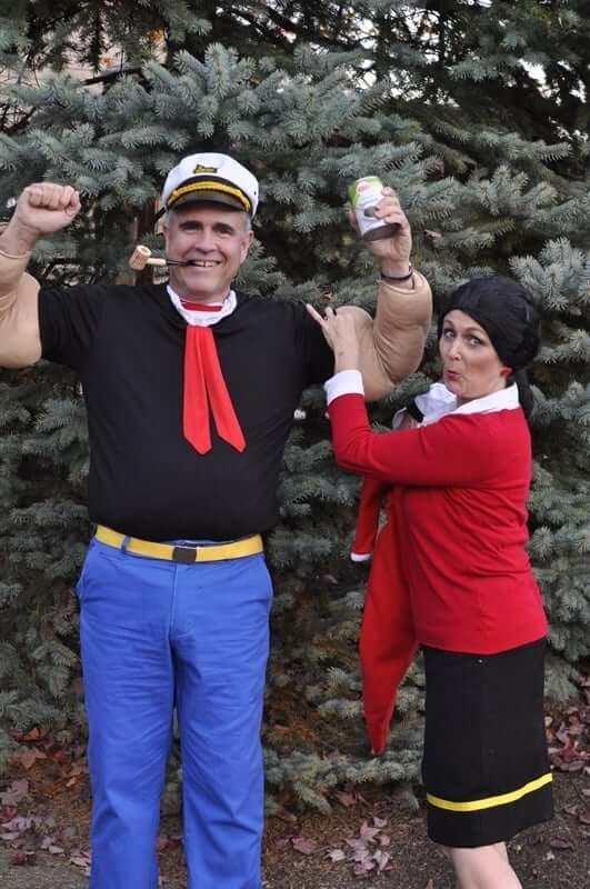 Man and woman dressed for halloween as popeye and olive oyl