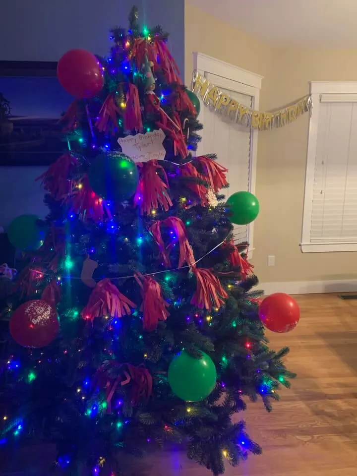 Birthday decorations on christmas tree.