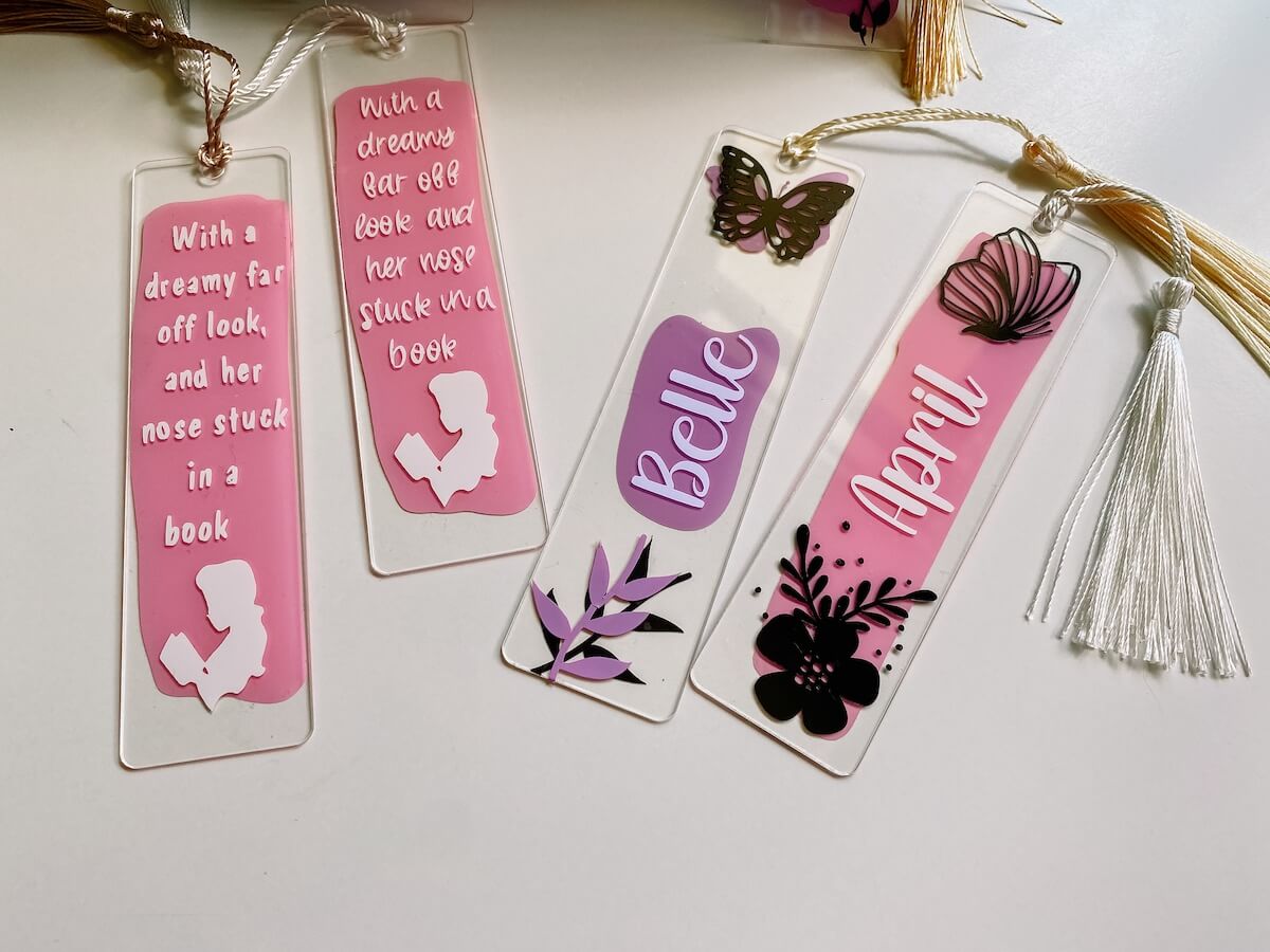 4 acrylic bookmarks with personalised cricut vinyl designs and tassels.