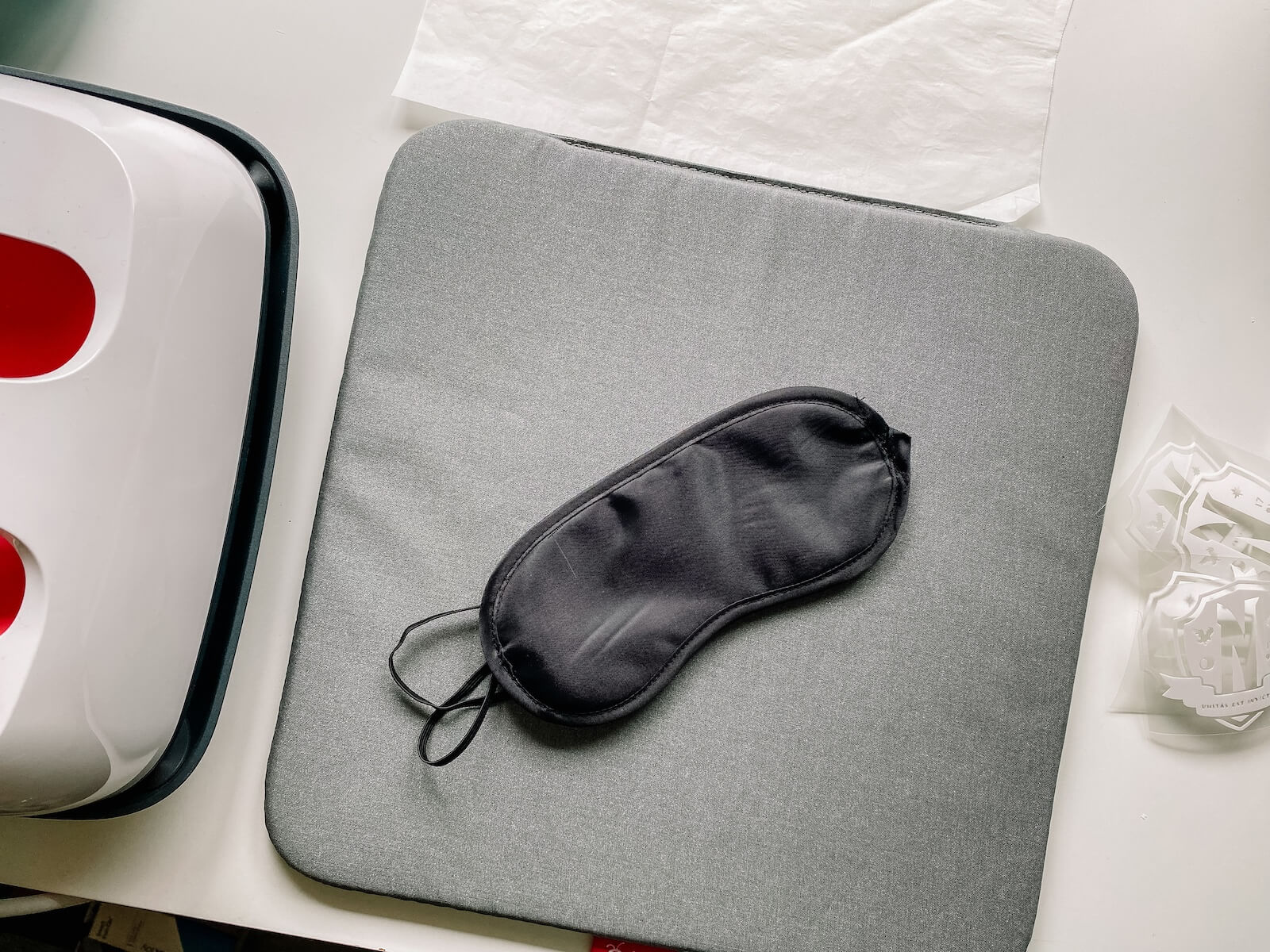 Blank black sleeping mask on a cricut heatpress mat.