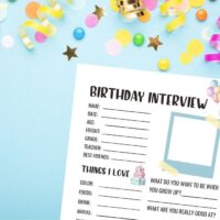 printable birthday questions for kids on a blue background with party streamers.