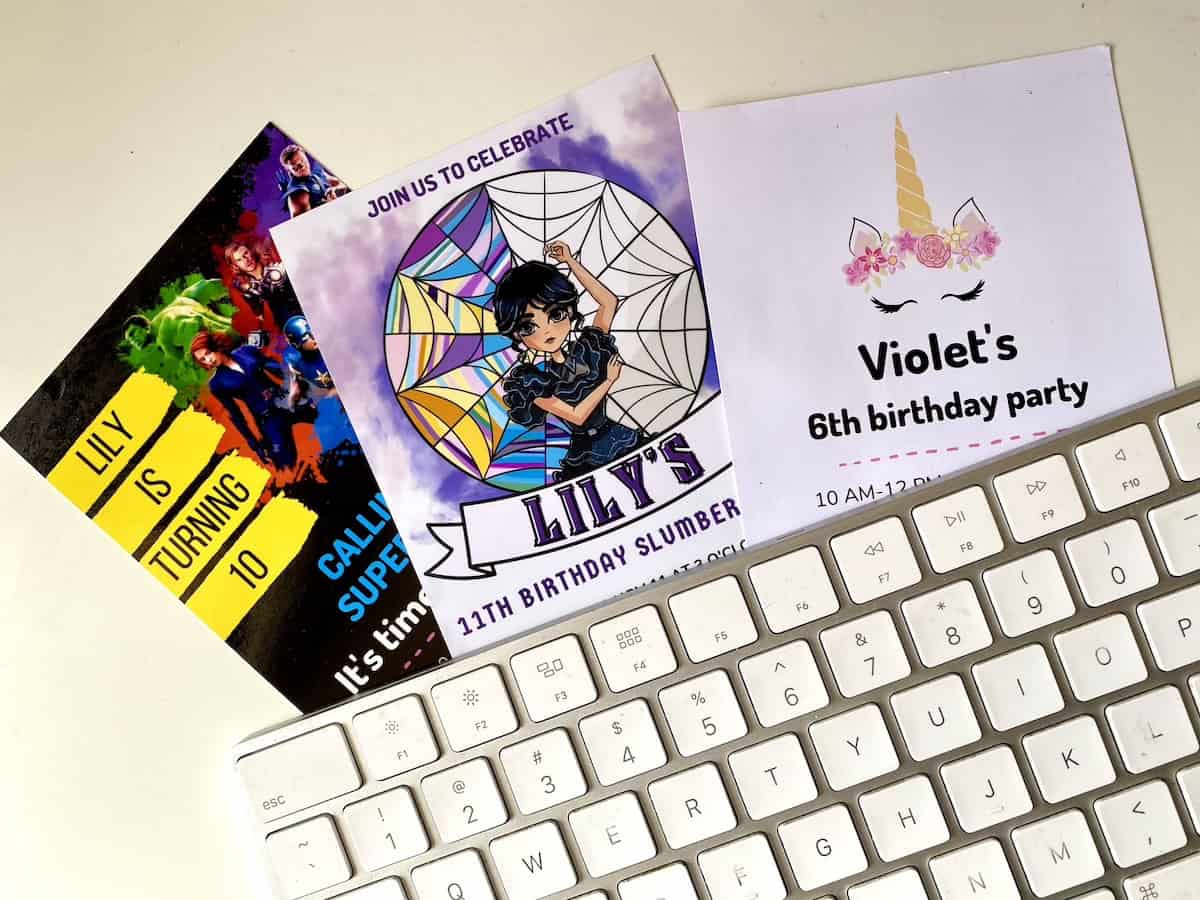 DIY party invitations for kids birthday sitting under a keyboard.