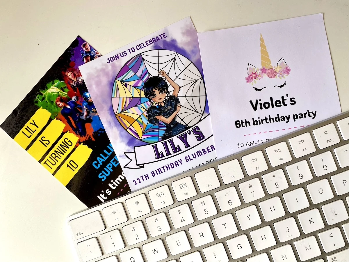 Diy party invitations for kids birthday sitting under a keyboard.