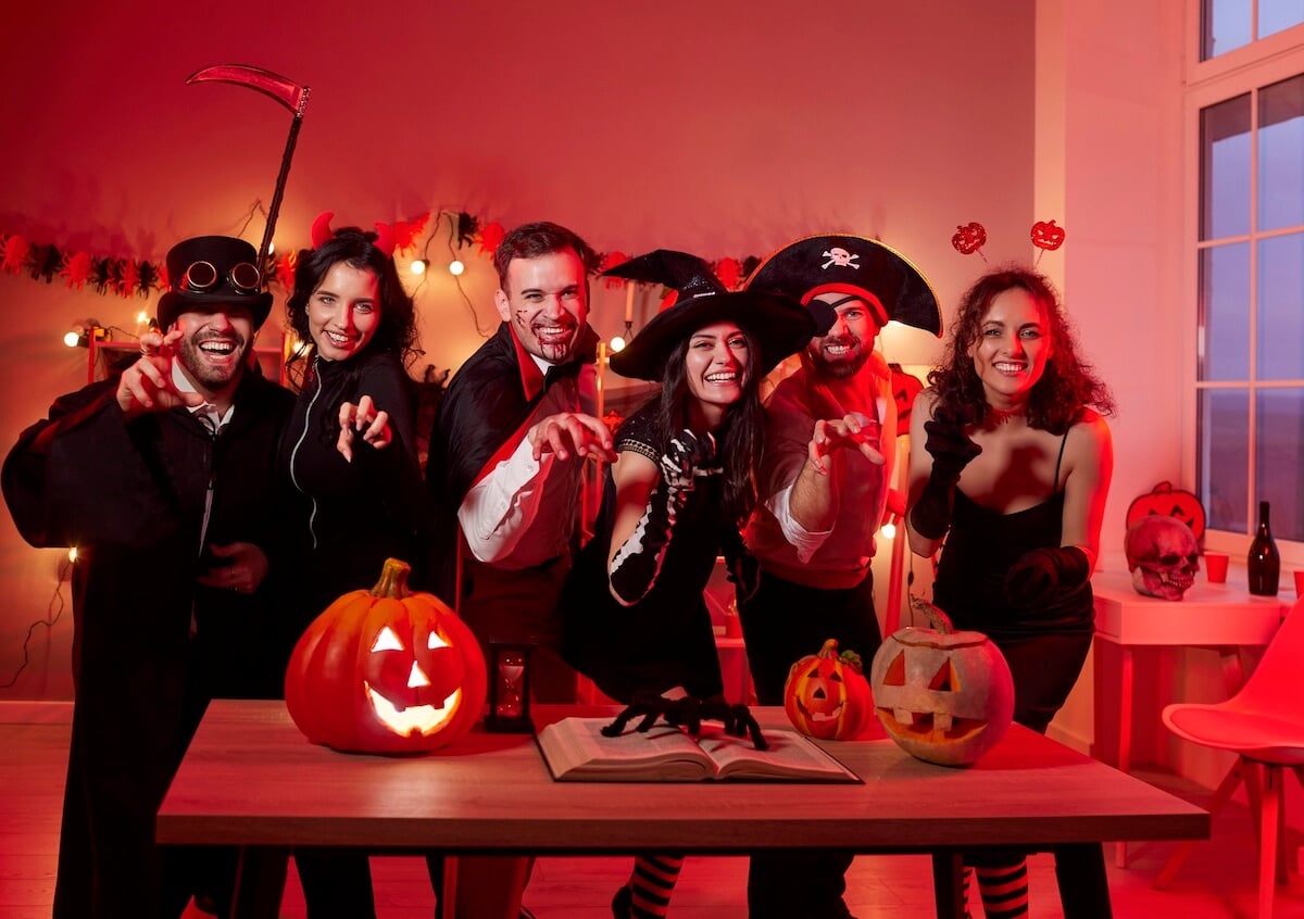 30 Spooky Halloween Party Themes For A Unique Celebration 1 group of adults at a halloween party.