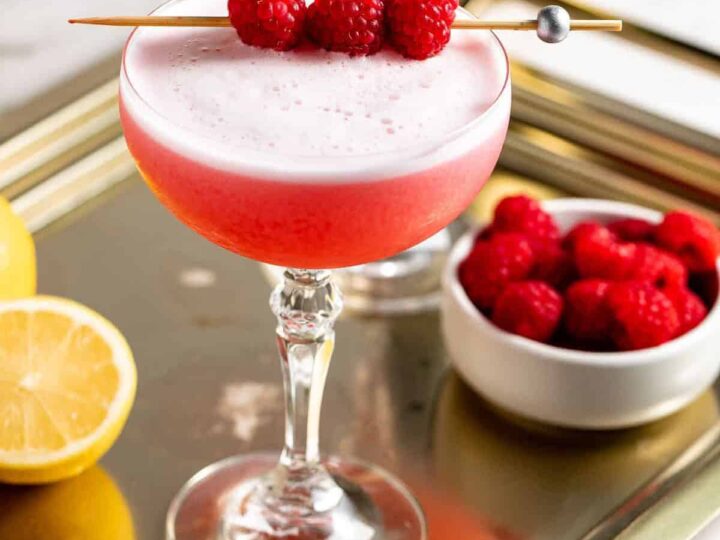clover club cocktail with raspberries.
