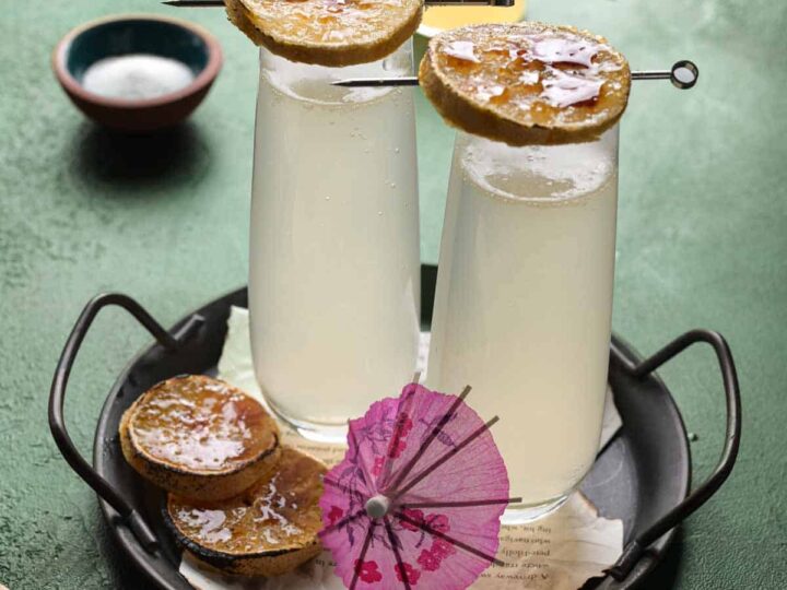 two glasses of lemonade mimosas on a tray.