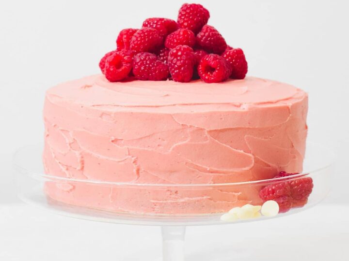 raspberry white chocolate cake on stand.