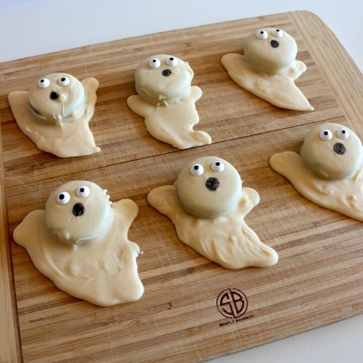 Oreo ghost treats on serving board.