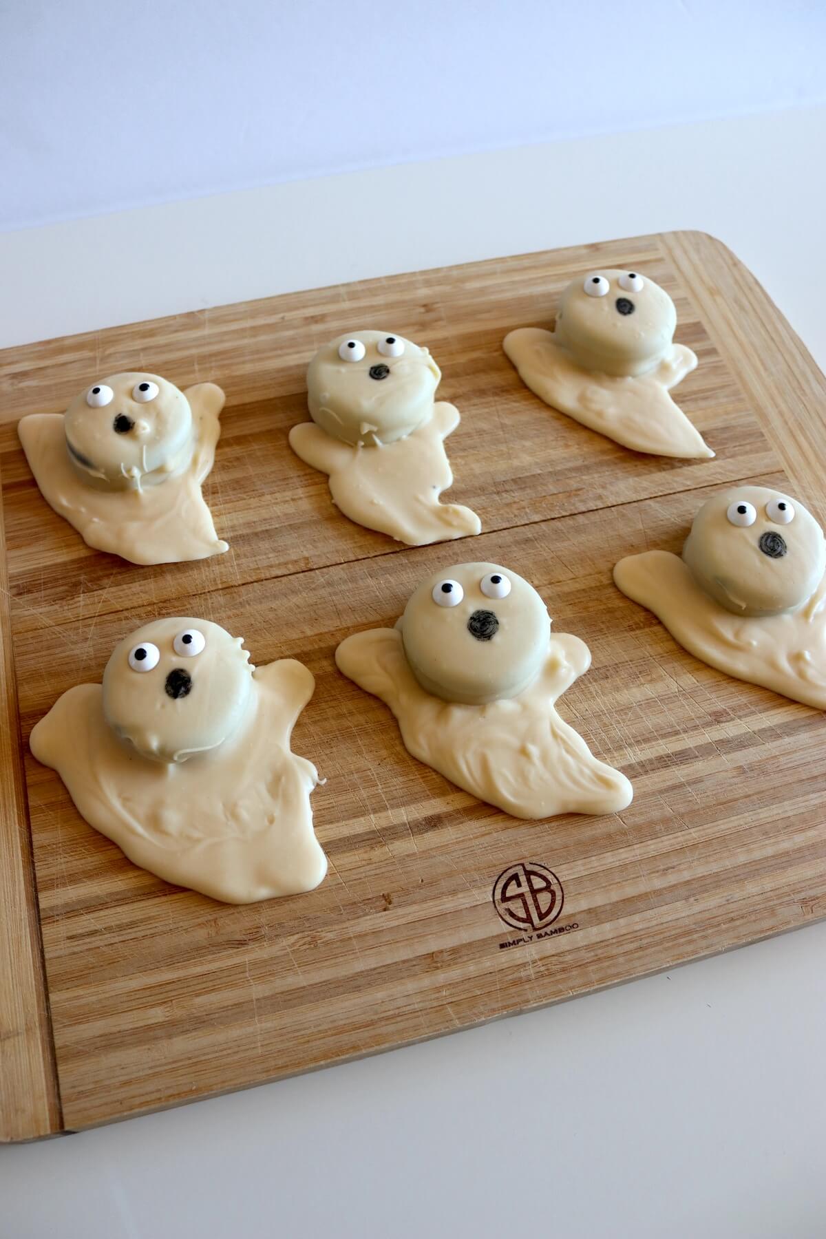 Oreo ghost treats on serving board.