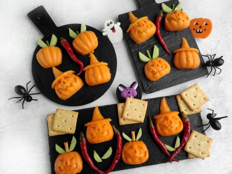 jack o lantern halloween cheese shapes on slate boards.