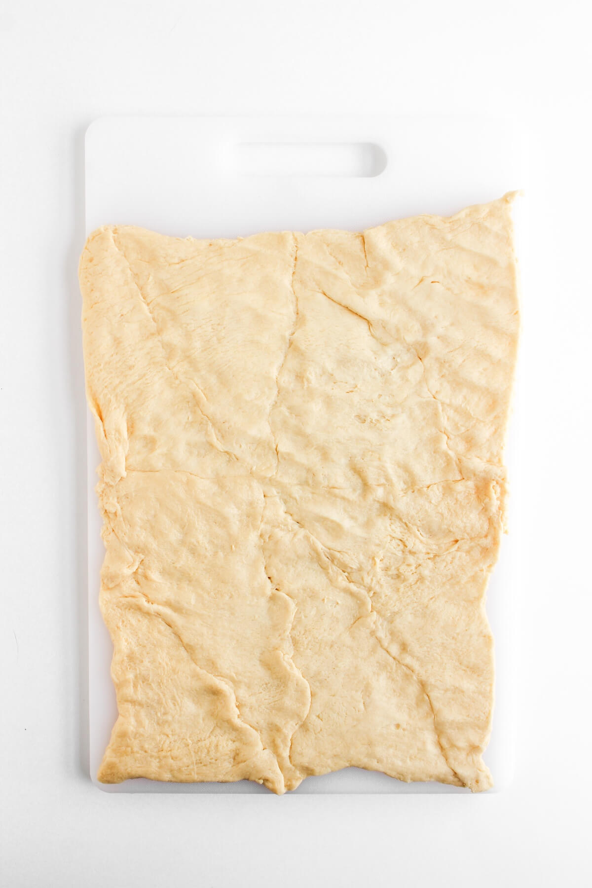 Halloween Mummy Sausages 3 rolled out crescent dough on board.