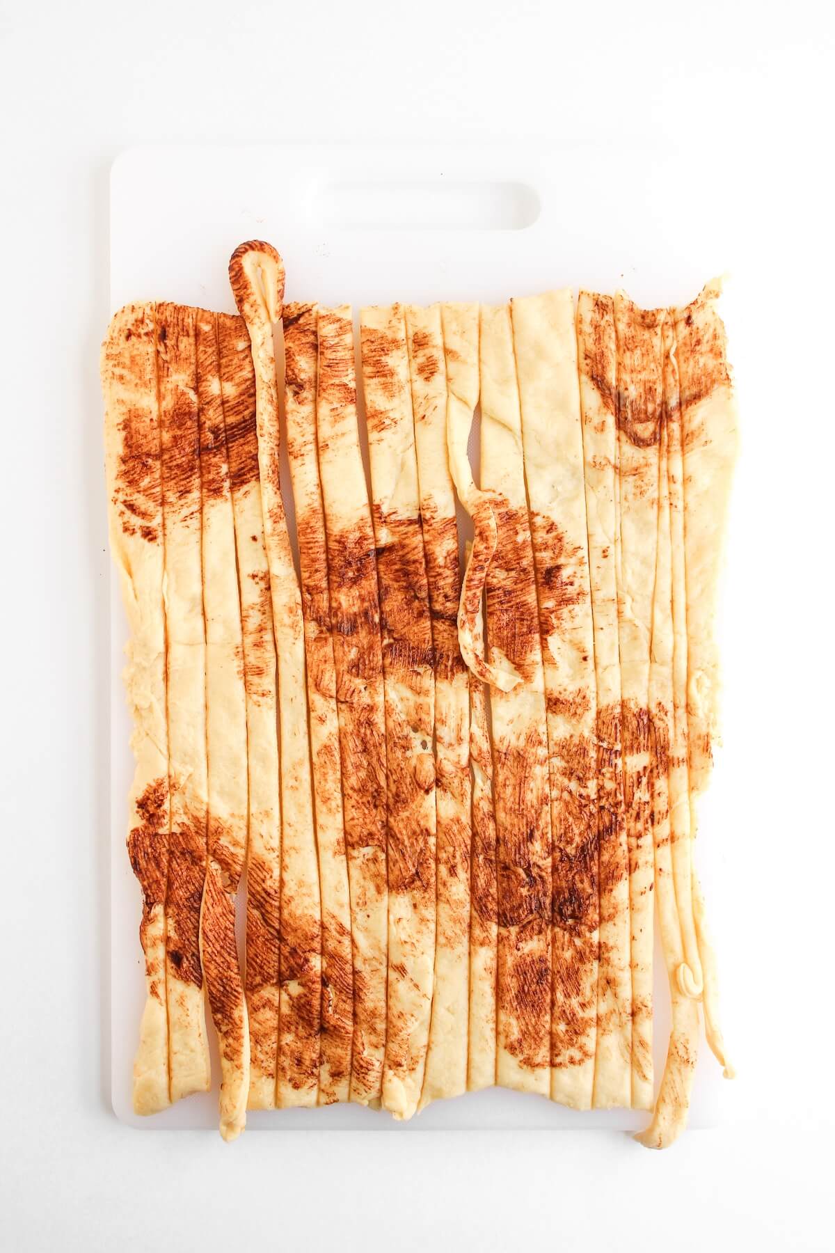 Halloween Mummy Sausages 5 crescent dough sliced in strips.