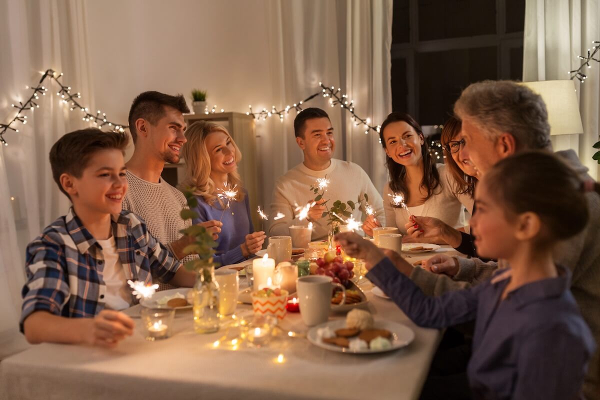 Family celebrating new year's eve together around a table.