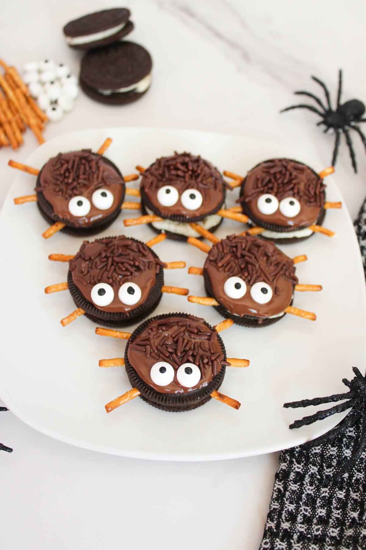 spider oreo cookies on a white plate.