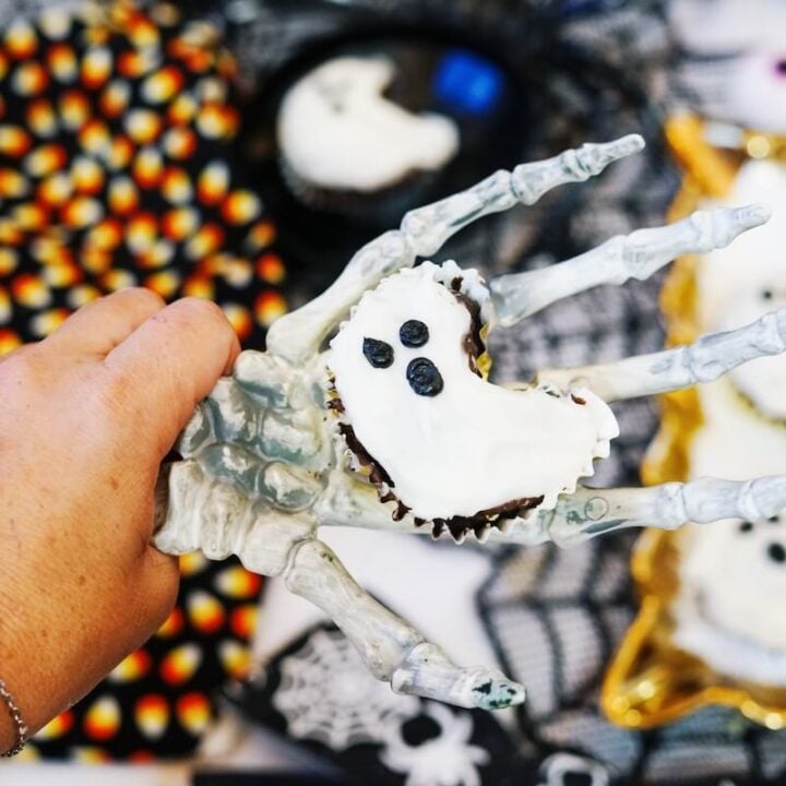 ghost cupcake on skeleton hand.